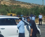 الشرطة وأطفال مخيم الشرطي الصغير يوزعون المياه على السائقين في سلفيت