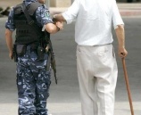 شرطي يساعد مسن بعبور الطريق