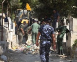 الشرطة والامن الوطني يقومان بتنظيف المقابر في نابلس بالتعاون مع البلدية .