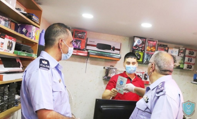 الشرطة تشارك في حملة توزيع كمامات في جنين